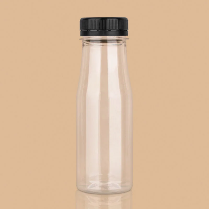 Clear 200ml plastic PET milk bottle with a black screw cap against a tan background.