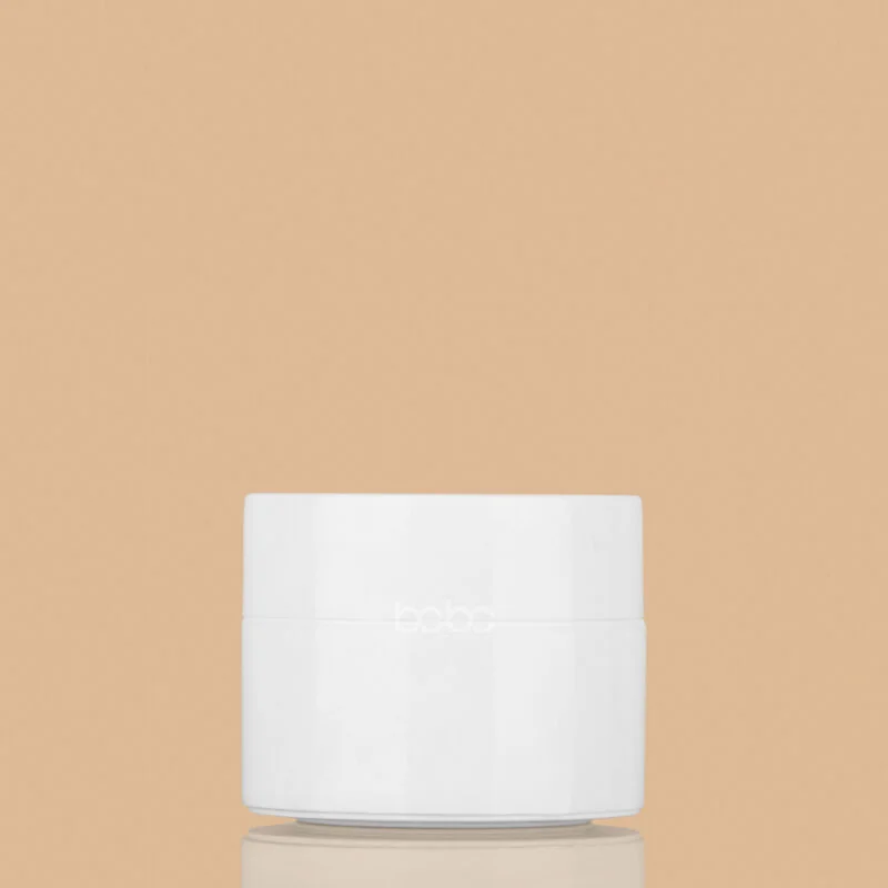 50GM-DW-JAR-_WHITE-WITH-CAP_-800x800 50g white double-wall cosmetic jar with a matching white screw cap, shown against a neutral beige background.