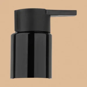 A glossy black beak pump dispenser cap shown against a neutral tan background.