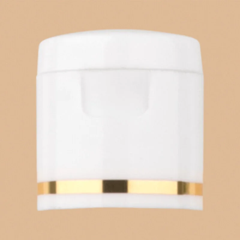 White flip top cap with a decorative golden ring detail.